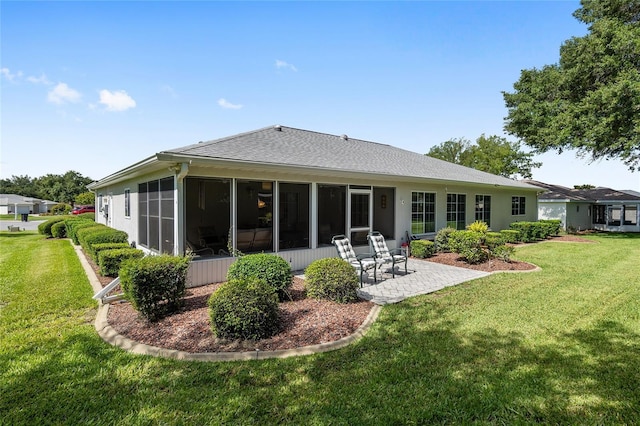 back of house featuring a patio area, a sunroom, and a yard