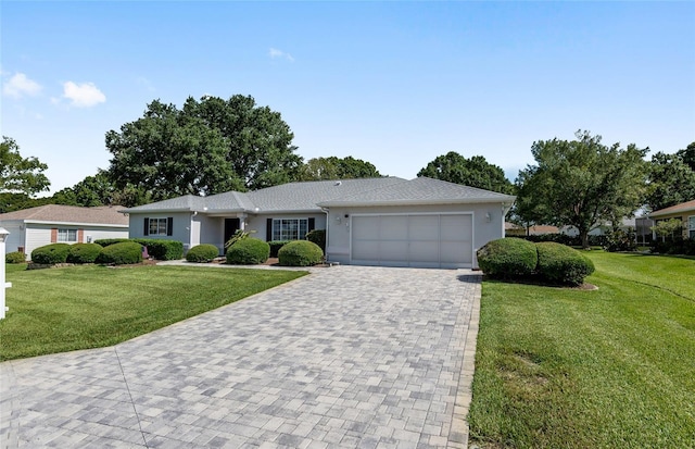 ranch-style home with a garage and a front lawn