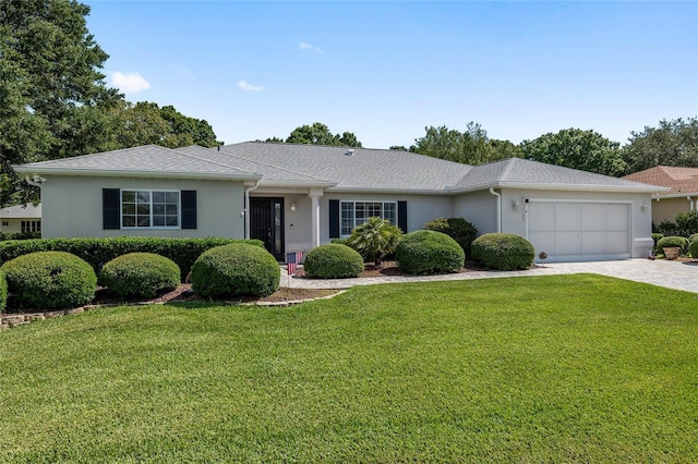 ranch-style home featuring a garage and a front lawn