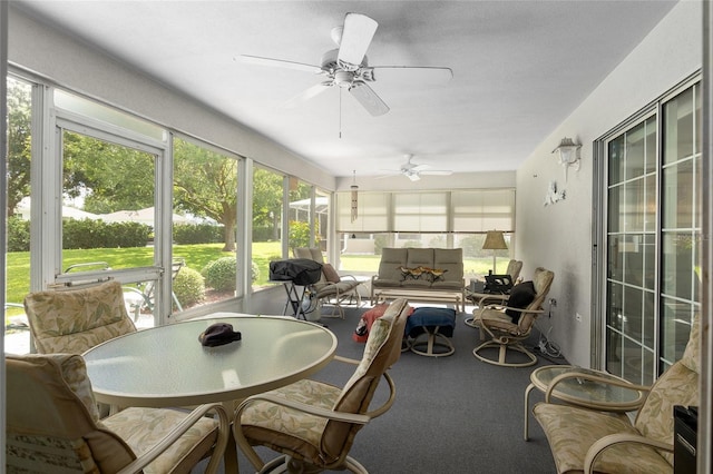 sunroom / solarium featuring ceiling fan