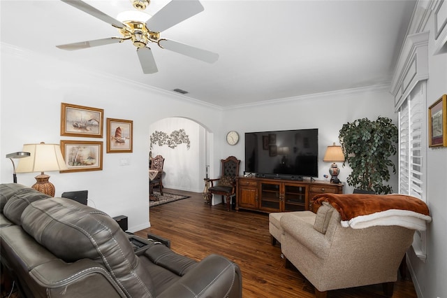 living room featuring ceiling fan, dark wood-type flooring, and ornamental molding