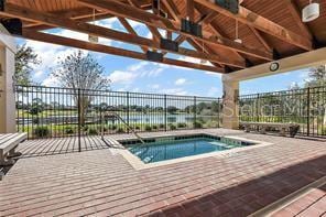 view of pool with a water view