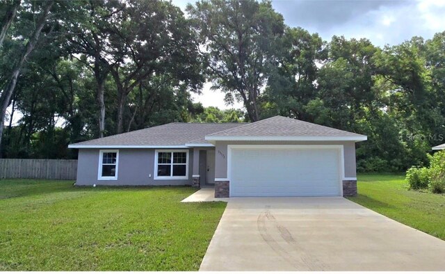 view of front facade featuring a front yard and a garage