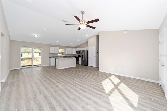 unfurnished living room featuring ceiling fan, light hardwood / wood-style flooring, and vaulted ceiling