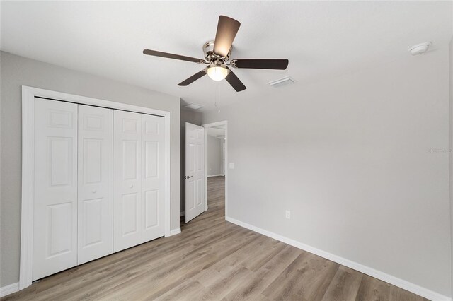 9692 N Emellia Ave, Citrus Springs, FL 34433 - unfurnished bedroom featuring baseboards, a closet, light wood finished floors, and visible vents