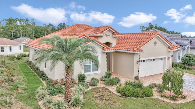 mediterranean / spanish-style house featuring a garage