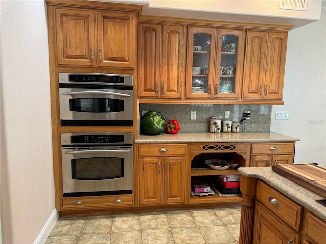 kitchen featuring backsplash and stainless steel double oven