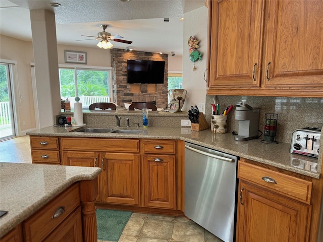 kitchen featuring stainless steel dishwasher, ceiling fan, a healthy amount of sunlight, and sink