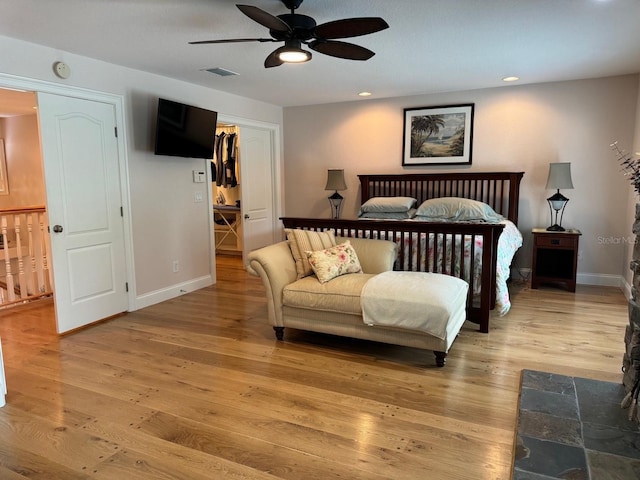 bedroom with ceiling fan and light hardwood / wood-style floors