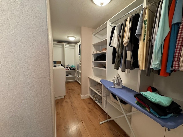 spacious closet featuring light hardwood / wood-style flooring