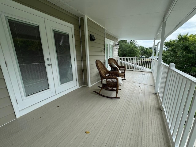 wooden deck with a porch and french doors