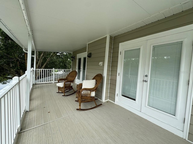 deck with covered porch and french doors