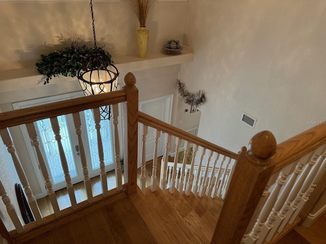 stairway with hardwood / wood-style flooring