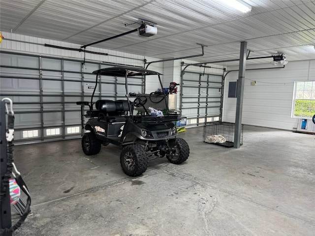 garage featuring electric panel and a garage door opener