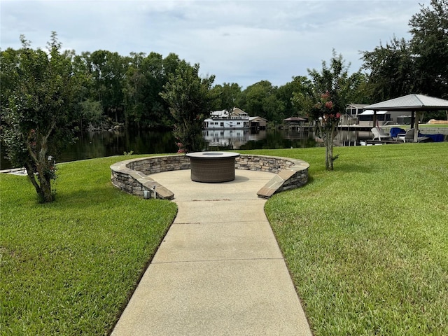 view of home's community featuring a yard and a water view