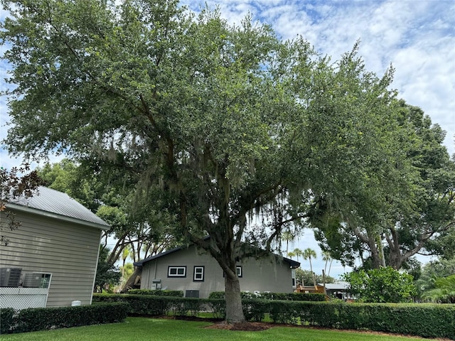 view of home's exterior featuring central AC and a yard