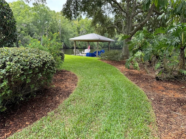 view of yard featuring a gazebo and a water view