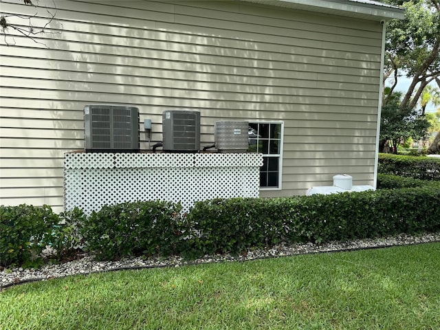 exterior space featuring a yard and central AC unit