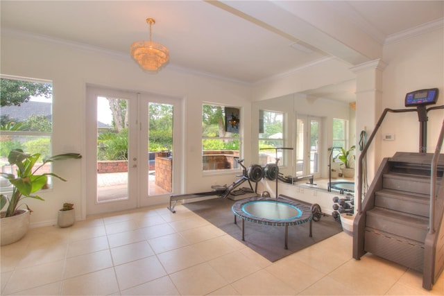 exercise room featuring french doors, ornate columns, light tile patterned floors, ornamental molding, and a healthy amount of sunlight