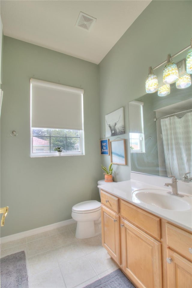 bathroom featuring tile patterned flooring, vanity, and toilet