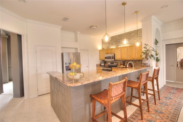 kitchen featuring crown molding, appliances with stainless steel finishes, light brown cabinetry, and kitchen peninsula