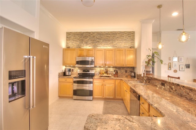 kitchen featuring appliances with stainless steel finishes, sink, light brown cabinets, and decorative light fixtures