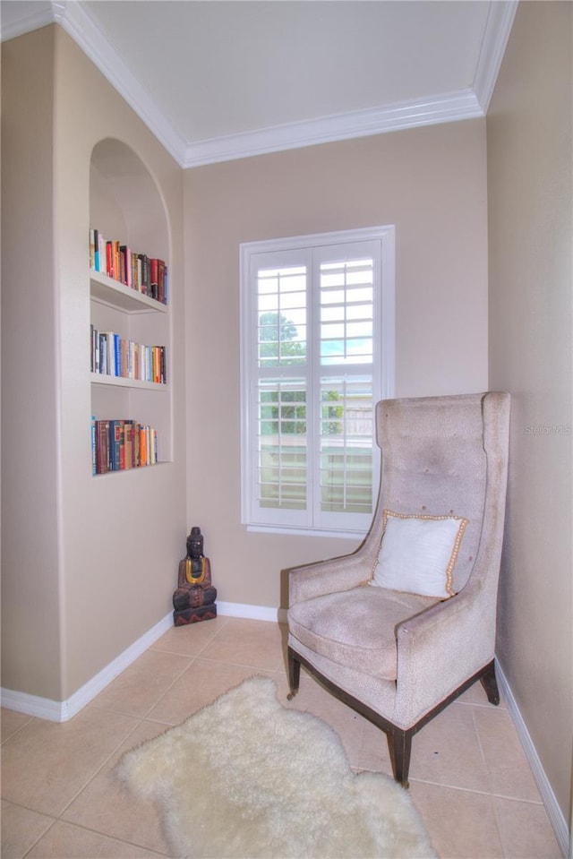 living area with crown molding, built in features, and light tile patterned floors