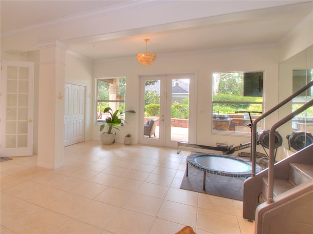 entryway with french doors, ornamental molding, and light tile patterned floors