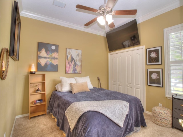 carpeted bedroom featuring ceiling fan, multiple windows, ornamental molding, and a closet