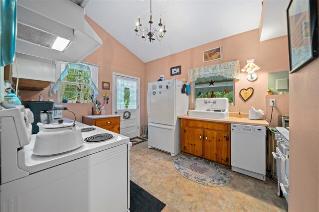 kitchen with vaulted ceiling, white appliances, a chandelier, and ventilation hood