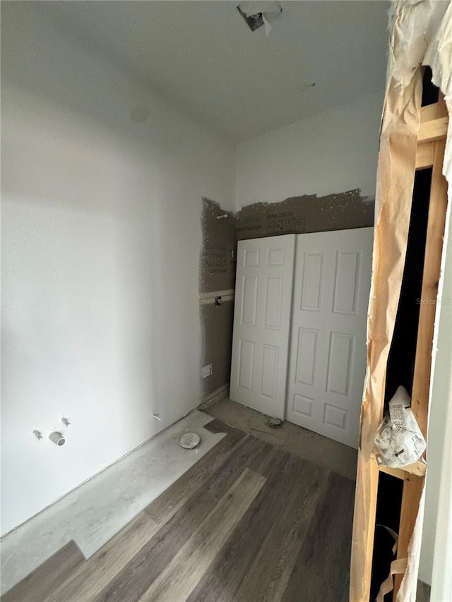 unfurnished bedroom with a closet and hardwood / wood-style floors