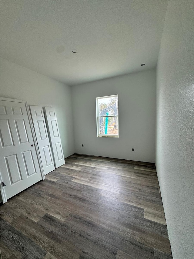 unfurnished bedroom featuring dark hardwood / wood-style floors