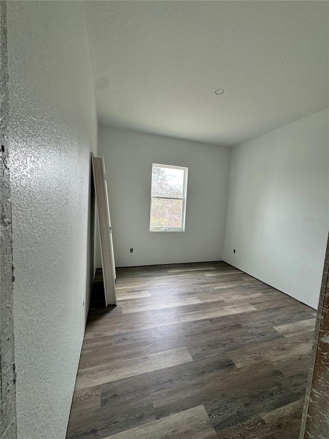 spare room with wood-type flooring