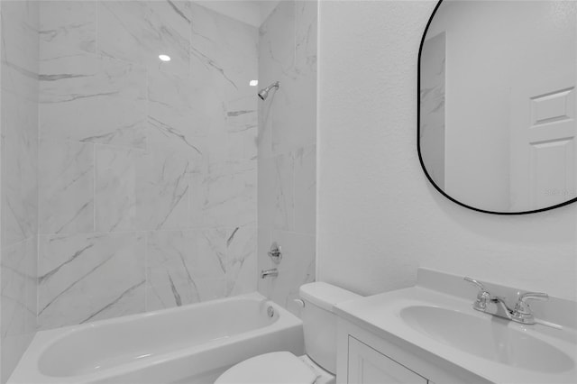 full bathroom featuring toilet, vanity, and tiled shower / bath