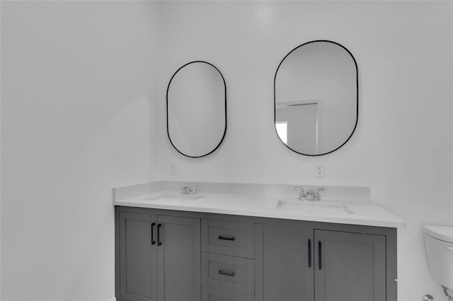 bathroom featuring toilet and vanity