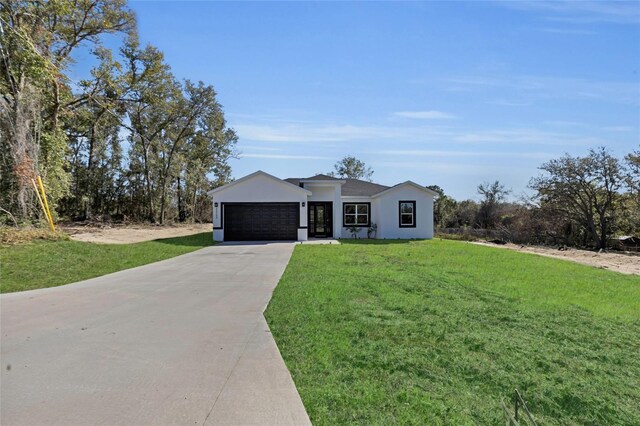 single story home with a front lawn and a garage