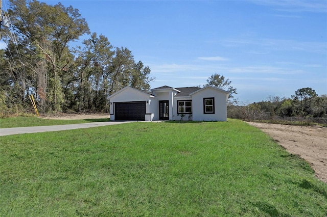 view of front facade with a front lawn and a garage