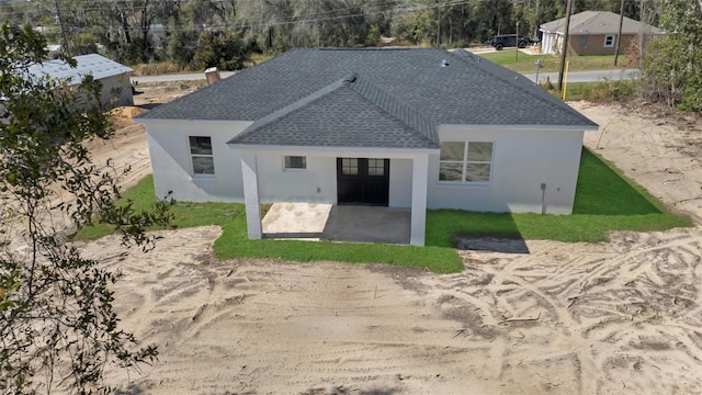 back of property with a patio