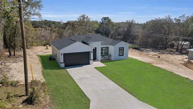 view of front of home with central AC, a front yard, and a garage