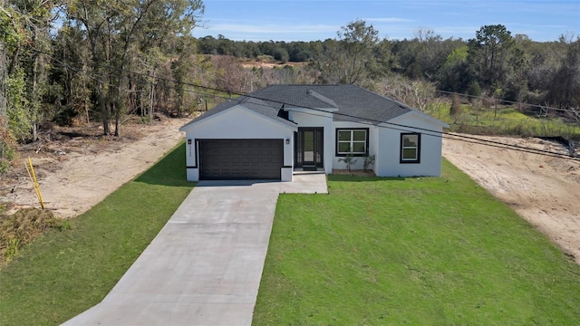 view of front of home with a front yard and a garage