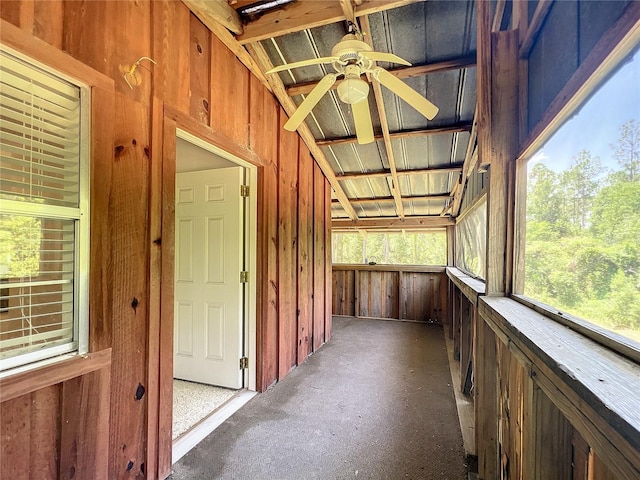 unfurnished sunroom with ceiling fan