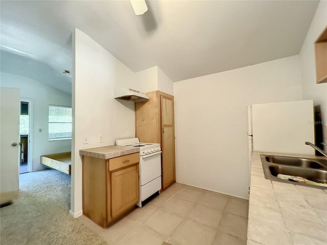 kitchen featuring white electric stove, vaulted ceiling, sink, and light tile patterned floors