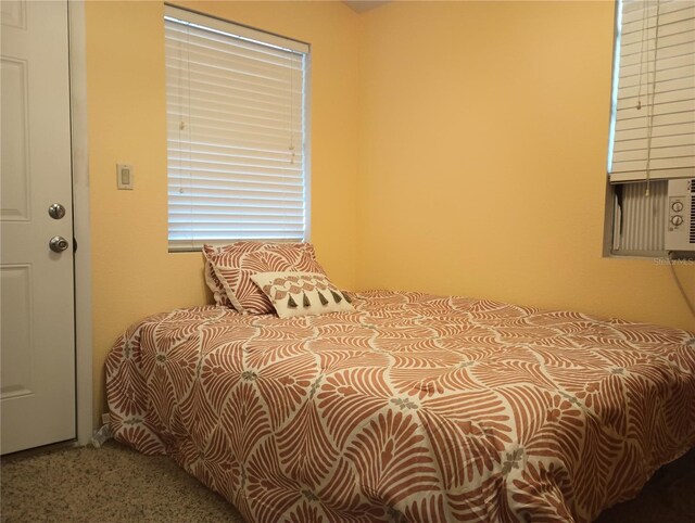 bedroom featuring cooling unit and carpet