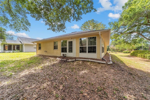 back of property featuring a yard