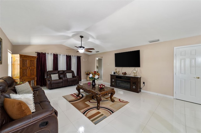 tiled living room with ceiling fan and vaulted ceiling