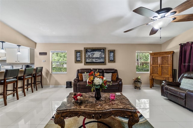 living room with plenty of natural light, light tile patterned flooring, and ceiling fan