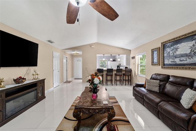 tiled living room featuring vaulted ceiling