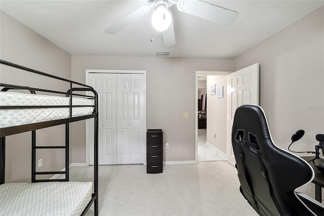 bedroom with ceiling fan and a closet