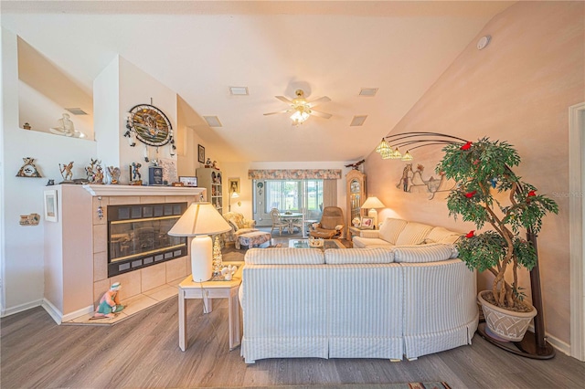 living room featuring ceiling fan, wood-type flooring, and a fireplace