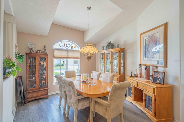 dining area featuring a notable chandelier, dark hardwood / wood-style floors, and a textured ceiling